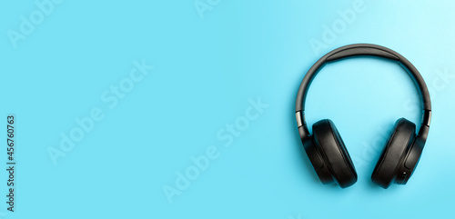 Wireless sound Audio headphones on a colored banner background. Music app, listening to podcasts, radio and audiobooks concept.