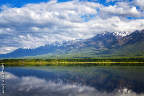 Landscape with mountains reflecting in the water on sunny day. Buryatia  Tunkinskaya valley