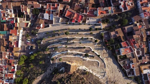mountain bikers climbing zig zag slopes in a village in Spain