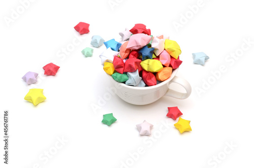 Color lucky stars over cup on white