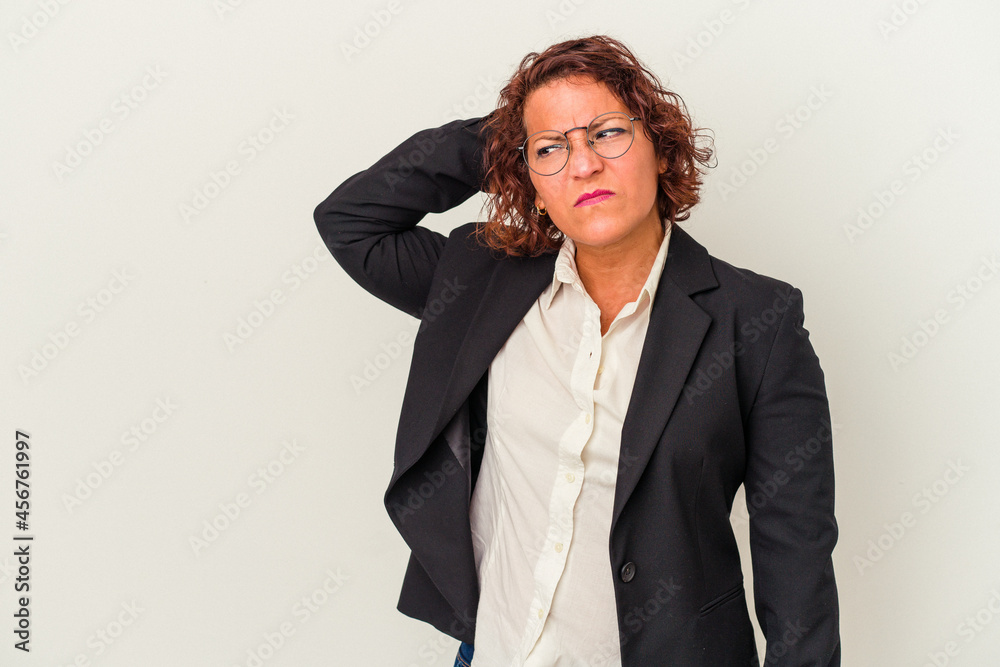 Middle age latin business woman isolated on white background touching back of head, thinking and making a choice. Middle age latin business woman isolated on white background touching back of head, thinking and making a choice.