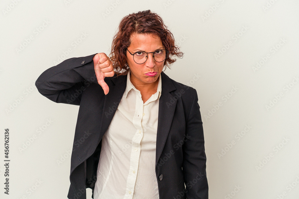 Middle age latin business woman isolated on white background showing a dislike gesture, thumbs down. Disagreement concept. Middle age latin business woman isolated on white background showing a dislike gesture, thumbs down. Disagreement concept.