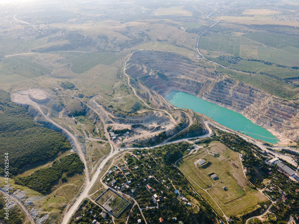 a large turquoise lake on the site of an old abandoned quarry from a bird's eye view. city ​​reservoir.