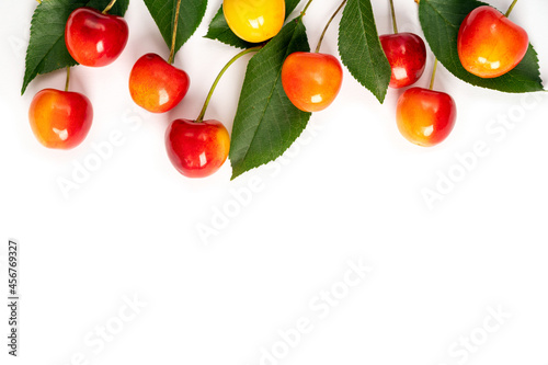 Fresh sweet yellow-red cherries on a white background. Top view, copy space photo