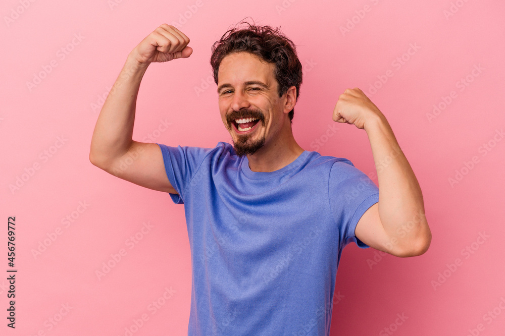 Young caucasian man isolated on pink background cheering carefree and excited. Victory concept. Young caucasian man isolated on pink background cheering carefree and excited. Victory concept.