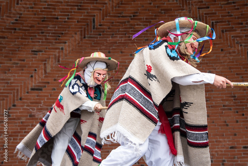 Mexican dancer from the dance of old men from Michoacan Mexico dressed in a woolen serape, a multicolored hat and an old man's mask, accompanied by a cane and an embroid photo