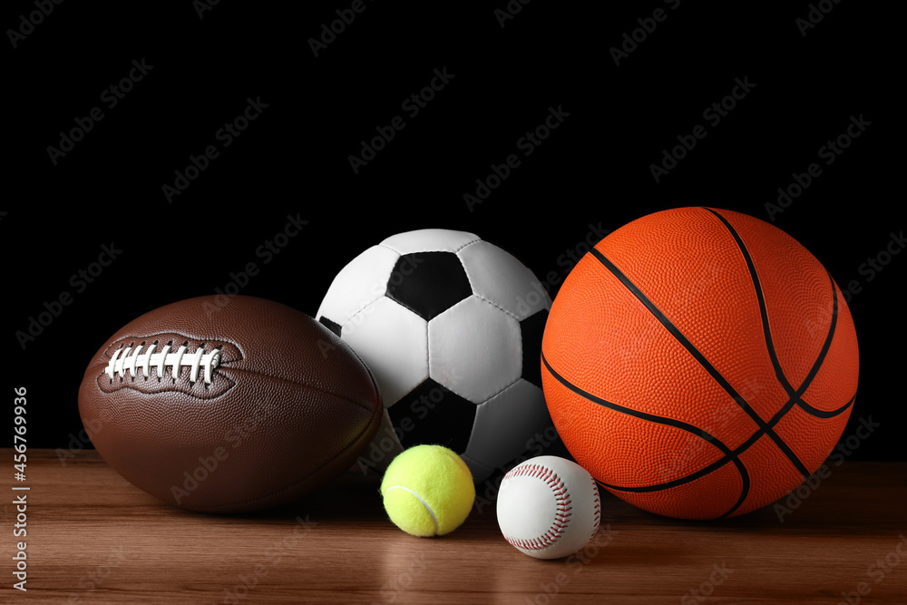 Set of different sport balls on wooden surface Set of different sport balls on wooden surface