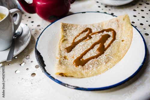 a caramel crepe on a table in a coffee shop photo