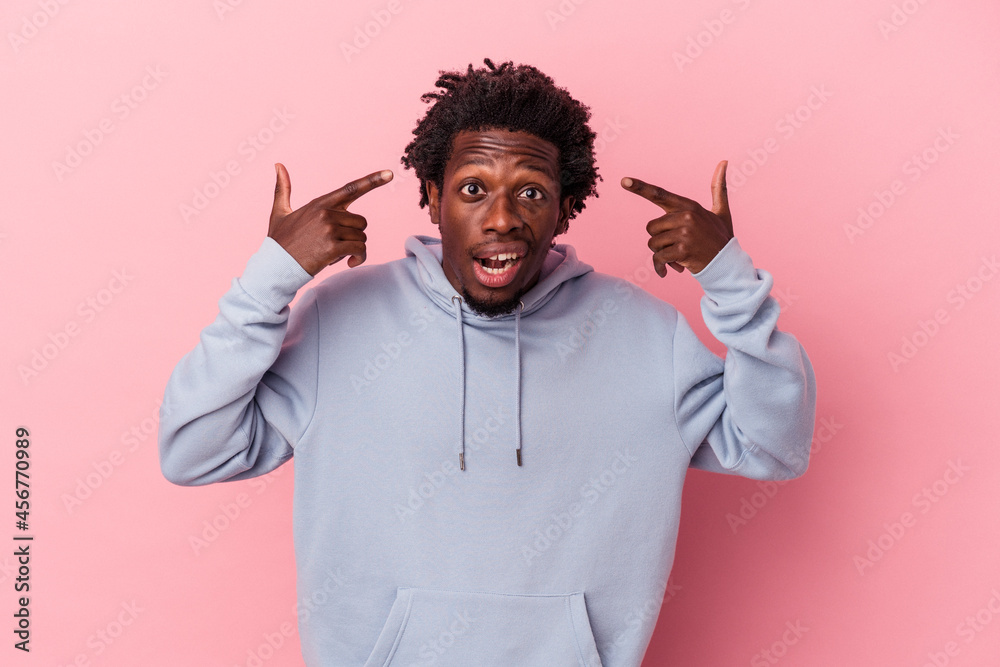 Young african american man isolated on pink background showing a disappointment gesture with forefinger. Young african american man isolated on pink background showing a disappointment gesture with forefinger.