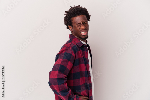 Young african american man isolated on white background  suffering a back pain.