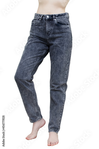 Caucasian woman gray jeans barefoot. White isolate.