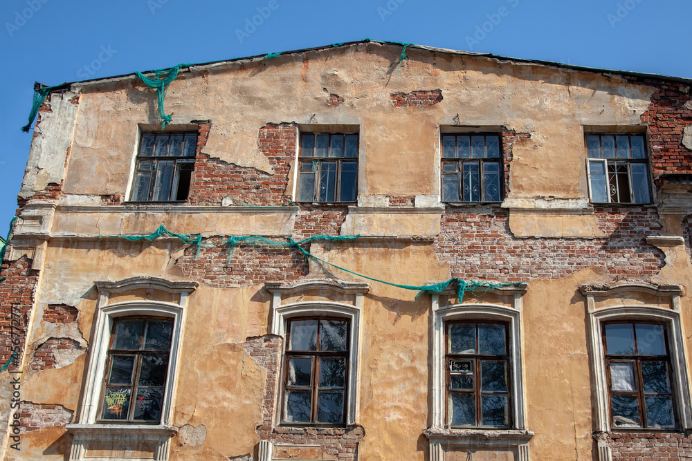 old city building, with a damaged and dilapidated facade