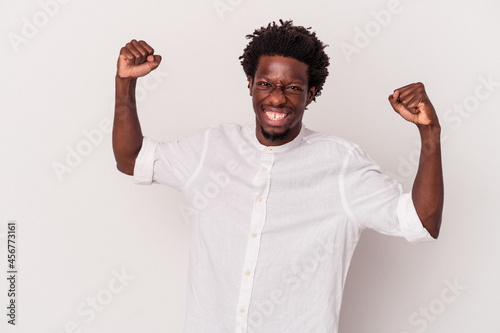 Young african american man isolated on white background cheering carefree and excited. Victory concept.