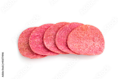 Red potato chips isolated on white background. Top view, close up.