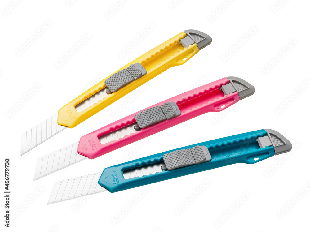 Yellow, pink and blue stationery knives for school and office are isolated on a white background. Copy space. Yellow, pink and blue stationery knives for school and office are isolated on a white background. Copy space.