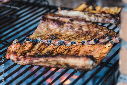 Delicious brown coocked ribs on a grill (barbecue) photo