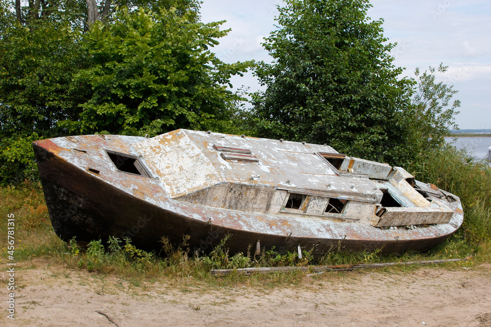 Abandoned wrecked fishing boat on the shore.