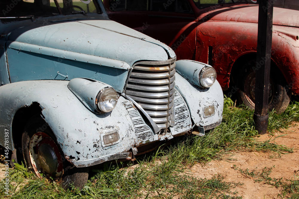 Old blue rusty car is abandoned. A classic car requires restoration.