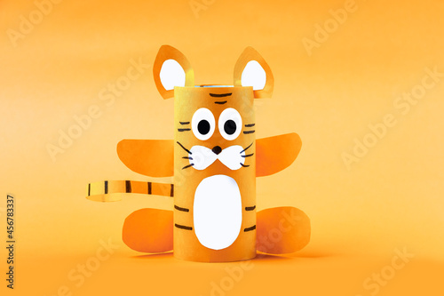 DIY and kid's creativity. Step by step instruction: how to make symbol of 2022 of tiger from toilet roll tube. Step3 finished craft. Children New year and christmas Craft . photo