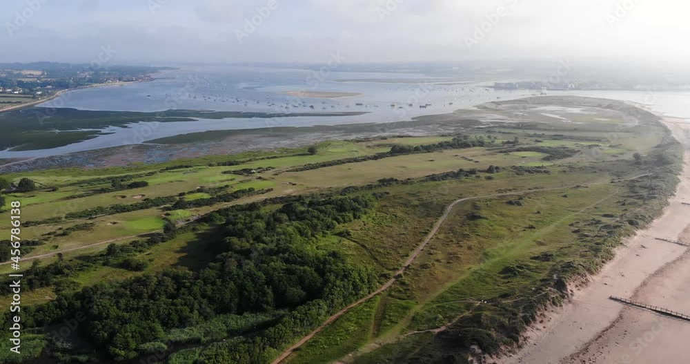 Aerial Across Dawlish Warren Golf Course and River Exe estuary. Dolly Back, Pan Left Aerial Across Dawlish Warren Golf Course and River Exe estuary. Dolly Back, Pan Left