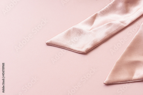 Handmade silk hair clip on pink background. Pink scrunchy. Elastic band for hair. Closeup