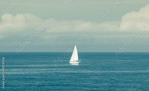 sailboat with storm clouds in the background