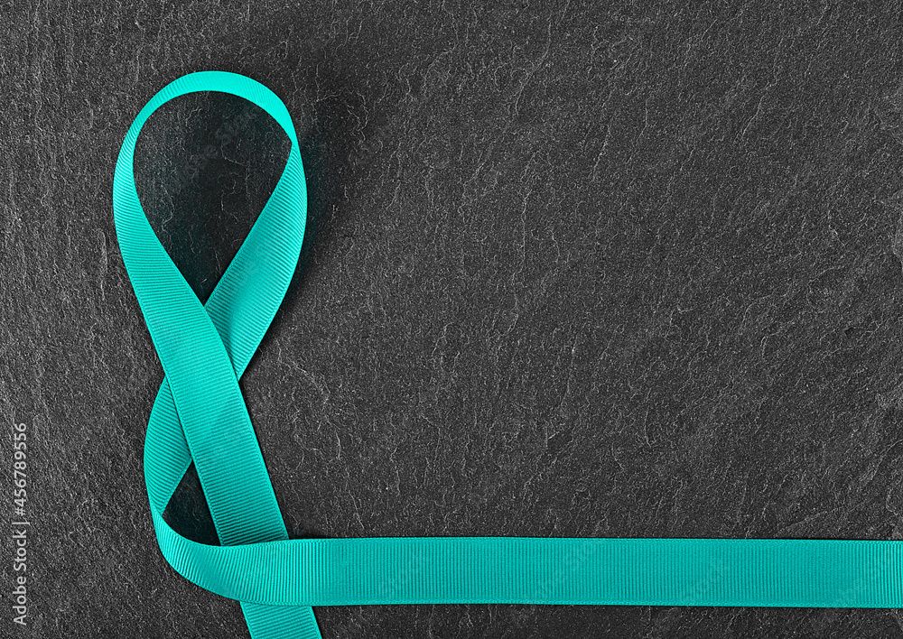 Teal awareness ribbon on black background. Symbol of сervical сancer,  sexual assault and uterine cancer. Stock Photo | Adobe Stock