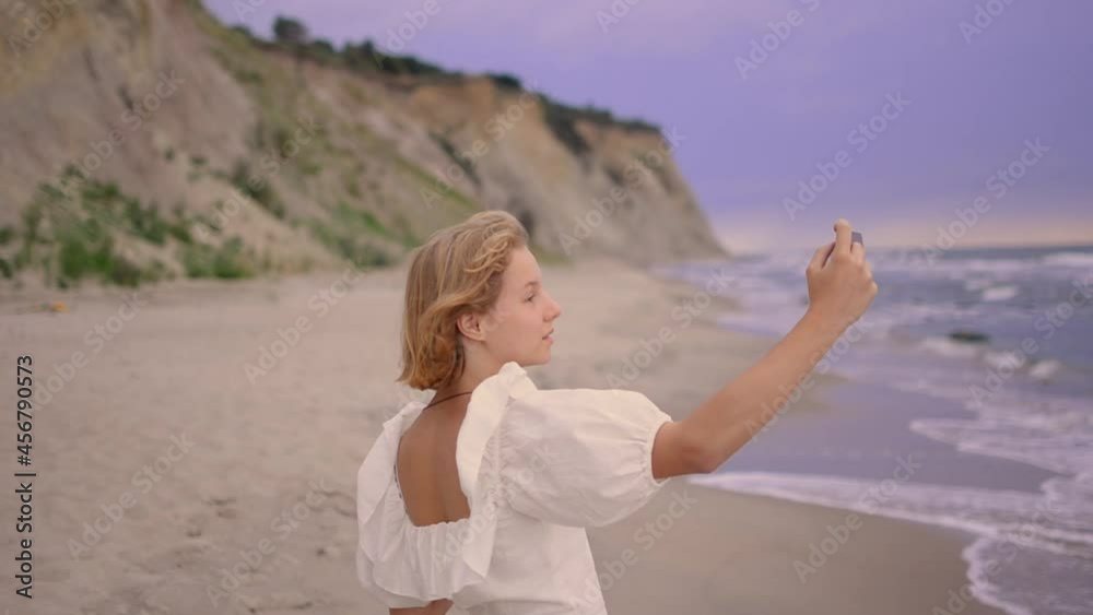 Close up of cheerful young blond girl taking a selfie. Close up of cheerful young blond girl taking a selfie.