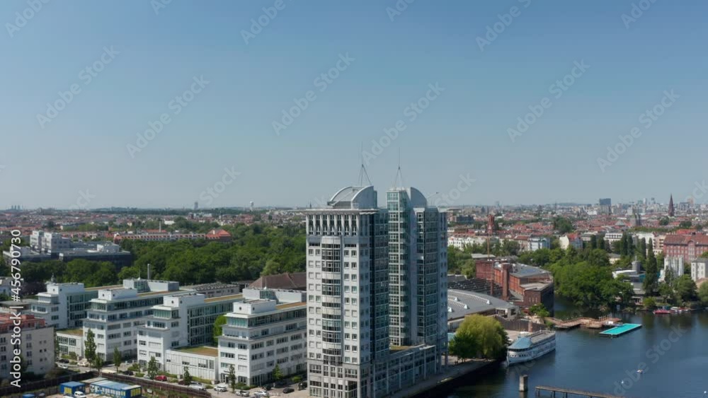 Forwards fly to office building Twin Towers by Spree river. Pair of modern tall buildings. Sunny day with clear sky. Berlin, Germany Forwards fly to office building Twin Towers by Spree river. Pair of modern tall buildings. Sunny day with clear sky. Berlin, Germany