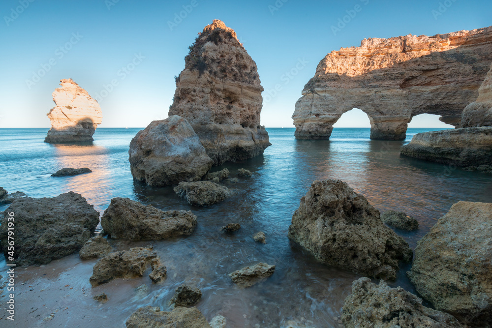 Sunny day in the Beach at Algarve, Portugal with turquoise sea in background. Bird eye view of the cliffs of Algarve. Aerial view. Concept for travel in Portugal and most beautiful places in Portugal.