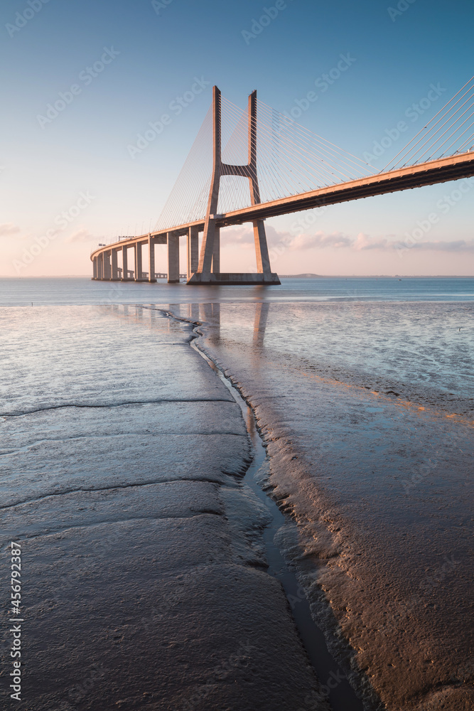 Fototapeta premium Amazing sunrise in Lisbon, watching the Vasco da Gama Bridge start to light up