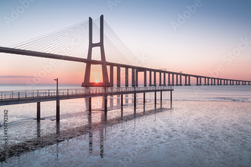 Amazing sunrise in Lisbon, watching the Vasco da Gama Bridge start to light up © Michal