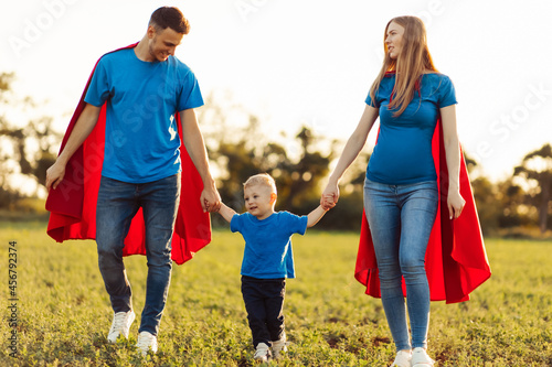 european superfamily concept, pregnant super mom, super father, father's day and mother's day