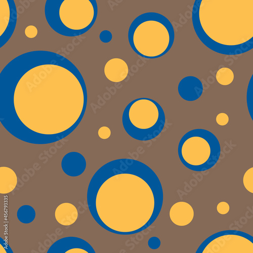 Vector seamless pattern. Trendy tones color of Fashion Spring Summer 2022. Blue and yellow circles on brown Coca Mocha background. Geometry wallpaper. Stylish cute print. Modern joyful design backdrop