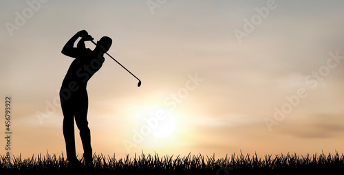 Playing golf at sunset. Man, golfer against the background of the sky and the sun. A man plays golf at sunset
