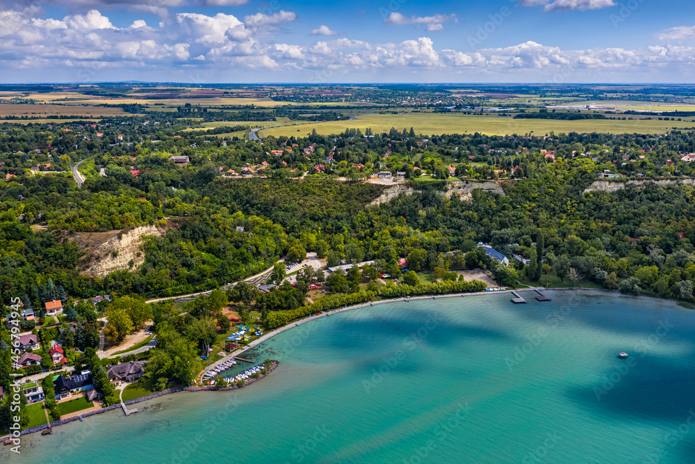 Balatonakarattya, Hungary - Aerial panoramic view of Bercsenyi Beach at Balatonakarattya on a sunny summer day with turquoise Lake Balaton, blue sky and clouds