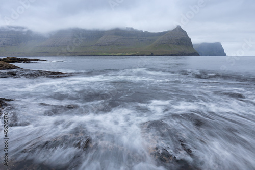 The top of the mountain of Faroe islands. A view of high peaks of mountains on a sunny day. Ocean view.  Beautiful panoramic view. Northern Europe. Travel concept © Michal