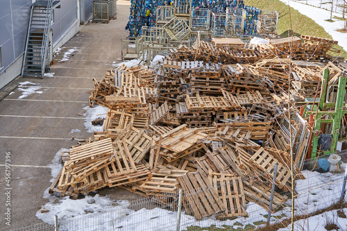 Many used pallets near the logistics center in early spring