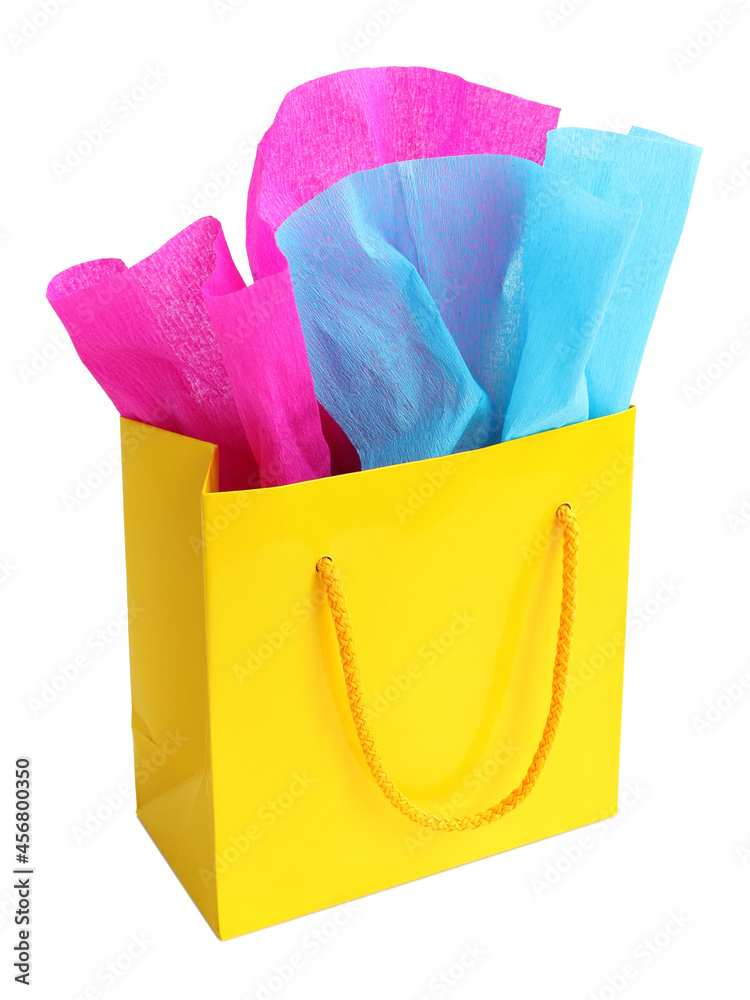 Yellow gift bag stuffed with pink and turquoise tissue paper, isolated on white Yellow gift bag stuffed with pink and turquoise tissue paper, isolated on white