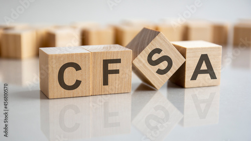 word CFSA on wooden cubes, gray background