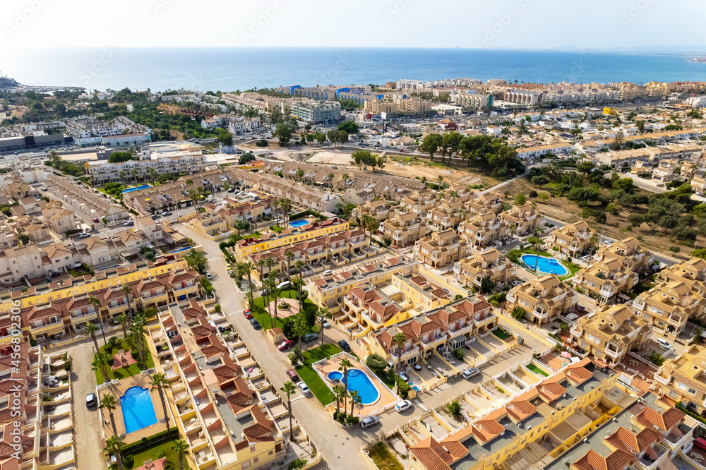 Drone point of view La Regia district and Dehesa de Campoamor neighbourhood luxury summer villas and houses with swimming pools. Europe, new build  buildings, holidays concept. Spain, Costa Blanca 