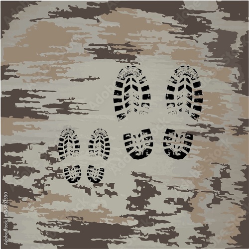 Black footprints of shoes. Small footprints next to large ones. Father with a child. Dirty shoe prints. Dad and son walk.