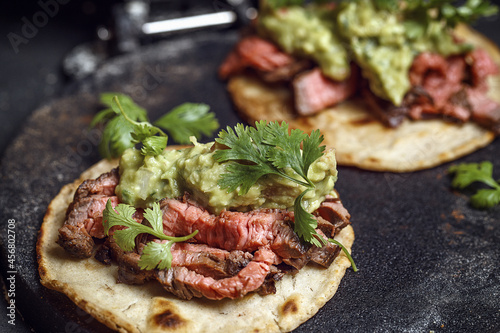 Canvastavla Process of cooking tacos with grilled flank beef steak with handmade guacamole o