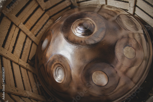 Photography baking this musical instrument hang drum in a muffle furnace in a metal hang pan
