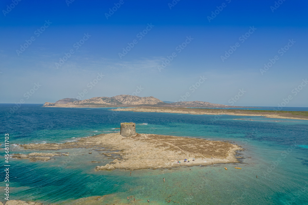 Aerial view of nuraghe in a island in Stintino, La Pelosa beach in Mediterranean sea. The nuraghe or also nurhag in English, is the main type of ancient megalithic edifice found in Sardinia.