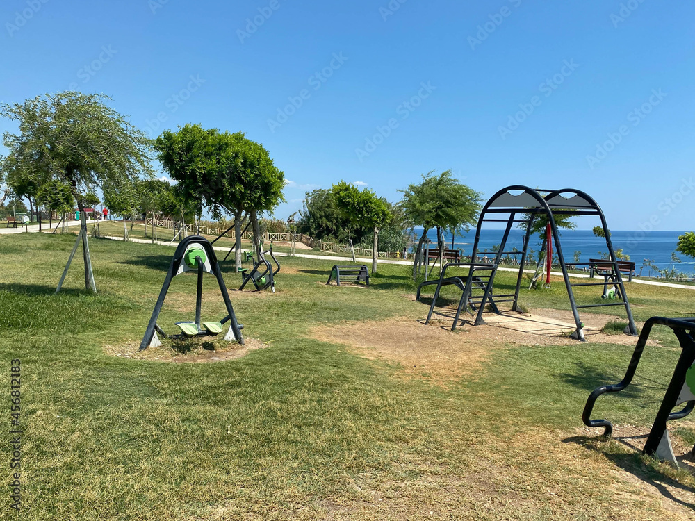 Outdoor exercise park detail. new green color stretching and workout equipment