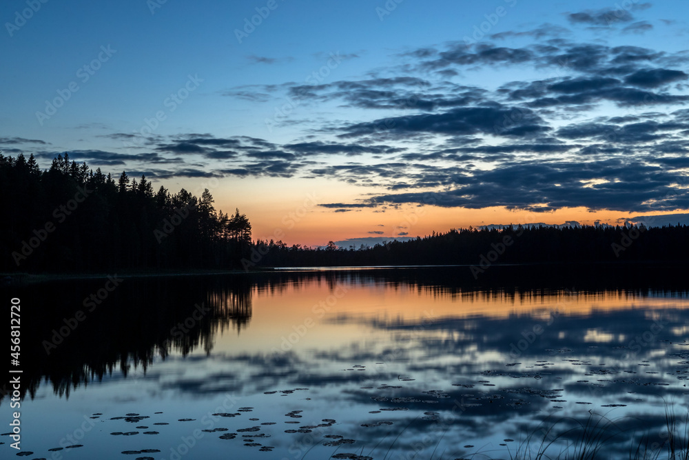 Night over the lake. Sunset. Blue sky. Red sunset. Night in the woods. Northern landscape.