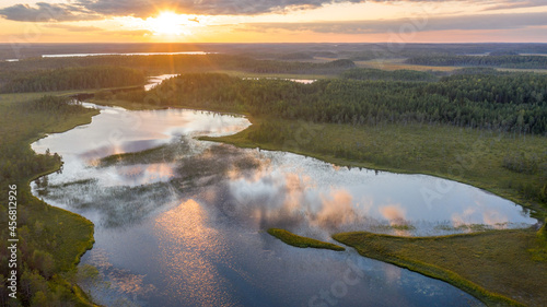 Northern nature. Panorama of the forest. Lake, forest, river. Beautiful landscape with lake and forest. Sunset and sunrise. Reflection of the forest in the water.