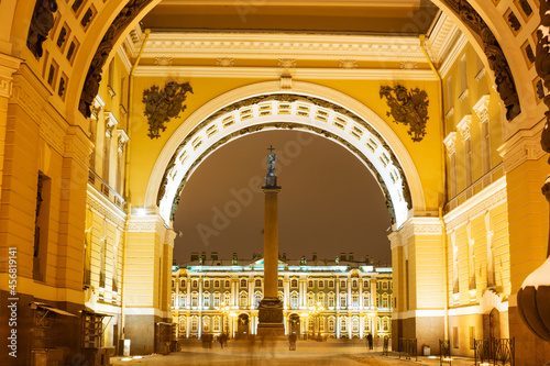 architectural ensemble with the Alexander column view through the arch. palace square at night, artificial lighting.