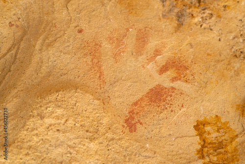 closeup of an ancient aboriginal hand print art on a rock shelter wall at dunns swamp photo